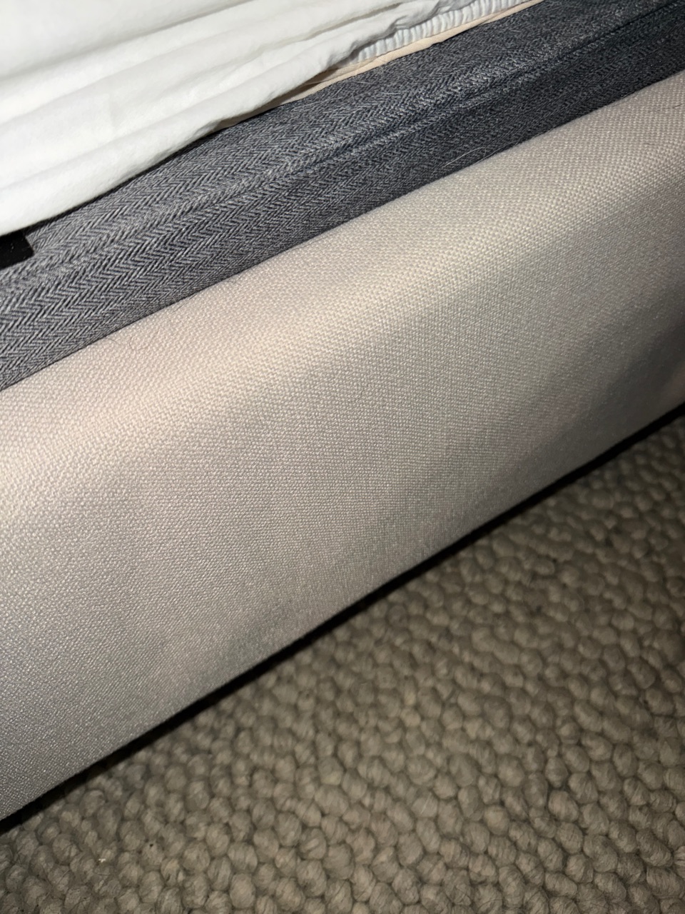 Upholstered bed frame after cleaning: the fabric is clean and free of hair and lint.